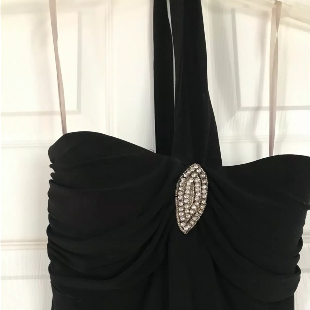 Short, black, halter dress. Removable broach